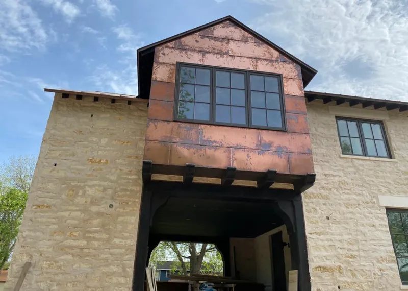 Copper metal panel facade on a stone building for Skylight Installation in Ladson